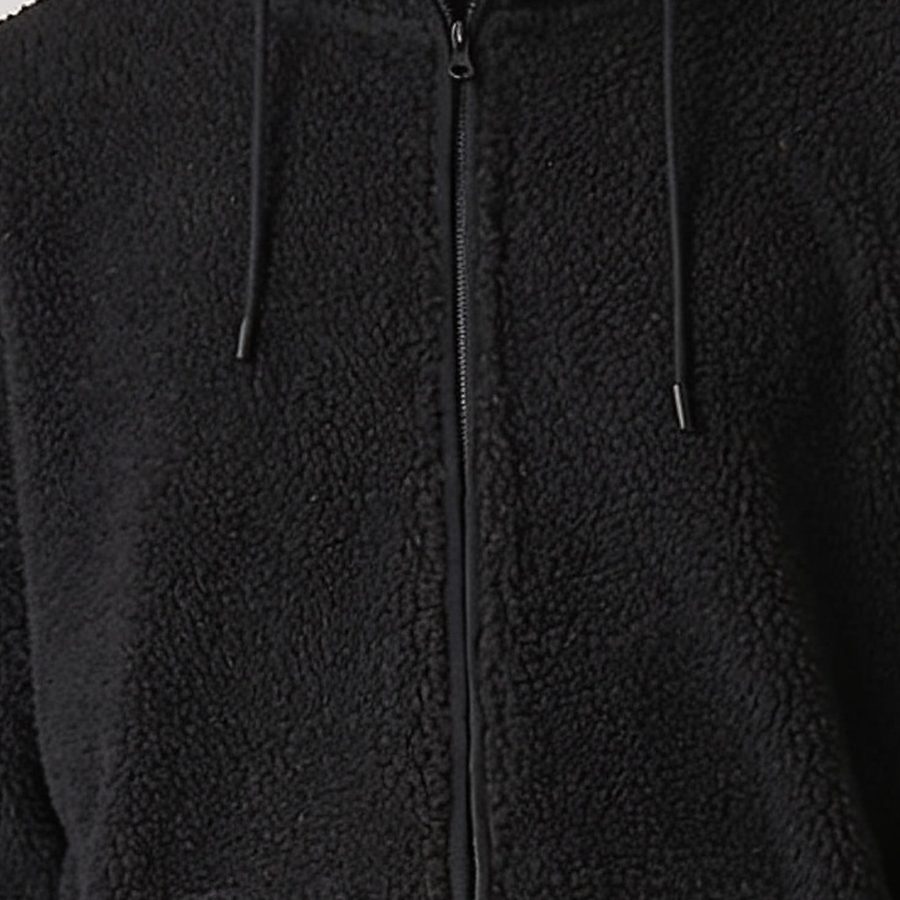 Close-up of black sherpa fleece pile and zip