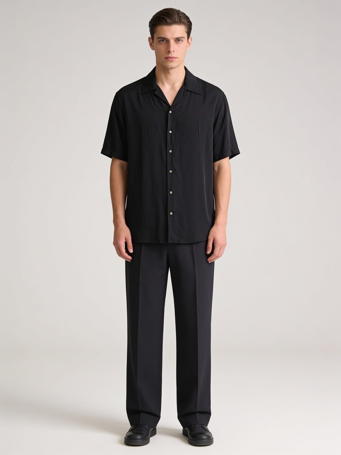 Model in a black short-sleeve camp-collar shirt